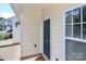 Exterior entryway featuring neutral siding, window, and dark colored front door at 168 Limerick Rd # C, Mooresville, NC 28115
