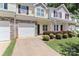 Charming townhouse exterior featuring stone accents, attached garage, and manicured landscaping at 168 Limerick Rd # C, Mooresville, NC 28115