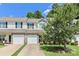 Inviting townhouse with stone accents, attached garage, and well-maintained front yard at 168 Limerick Rd # C, Mooresville, NC 28115