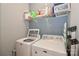 Clean laundry room features white washer and dryer and storage shelf at 168 Limerick Rd # C, Mooresville, NC 28115