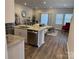 Modern kitchen with an island, stainless steel appliances, and an open view to the living room at 1843 Old Rivers Rd # 209, Concord, NC 28027