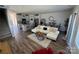 Open-concept living room with modern decor, wood flooring, and a view of the kitchen area at 1843 Old Rivers Rd # 209, Concord, NC 28027