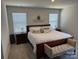 Relaxing bedroom with a large bed, comfortable seating, and ample natural light at 1843 Old Rivers Rd # 209, Concord, NC 28027