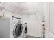 Functional laundry room with washer, dryer, water heater, and wire shelving for organized storage at 19725 Deer Valley Dr, Cornelius, NC 28031
