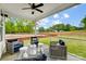 Inviting back porch with ceiling fan and outdoor seating area overlooking a green landscape at 2009 Autumn Dr # 2, Monroe, NC 28110
