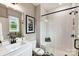 Bathroom with walk-in shower with white subway tile and dark fixtures, and a window providing natural light at 2009 Autumn Dr # 2, Monroe, NC 28110
