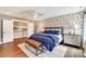Comfortable bedroom featuring wood floors, a patterned accent wall, and a large closet at 2009 Autumn Dr # 2, Monroe, NC 28110