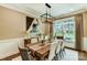 A dining room showcasing modern light fixture, neutral walls, and a large window providing natural light at 2009 Autumn Dr # 2, Monroe, NC 28110