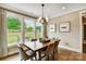Cozy dining room with a wooden table, upholstered chairs, and large windows at 2009 Autumn Dr # 2, Monroe, NC 28110