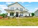 Charming two-story white home with a welcoming front porch and well-manicured lawn at 2009 Autumn Dr # 2, Monroe, NC 28110