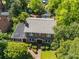 Aerial view of brick home with a large roof, surrounded by trees and well-maintained landscaping at 208 Park Ave, Wadesboro, NC 28170