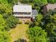 Aerial shot of the backyard with mature trees and a neighboring house, offering privacy at 208 Park Ave, Wadesboro, NC 28170