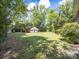 Large backyard featuring a detached two-car garage and mature trees, perfect for outdoor activities at 208 Park Ave, Wadesboro, NC 28170