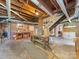 Spacious unfinished basement with brick walls, exposed wooden beams, stairs, and lots of potential at 208 Park Ave, Wadesboro, NC 28170