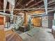 Unfinished basement with exposed ducts, brick accents, and stairs leading to the upper level at 208 Park Ave, Wadesboro, NC 28170