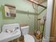 Small bathroom featuring an older style sink and toilet and green painted walls at 208 Park Ave, Wadesboro, NC 28170