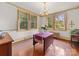 Dining room featuring a chandelier, hardwood floors, and windows overlooking greenery at 208 Park Ave, Wadesboro, NC 28170
