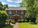 Classic brick home with neatly trimmed bushes, and a brick pathway leading to the front door at 208 Park Ave, Wadesboro, NC 28170
