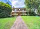 Charming two-story brick home featuring a landscaped front yard and inviting brick walkway at 208 Park Ave, Wadesboro, NC 28170