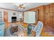 Living room with wood paneled walls, hardwood floors, and a built-in bookcase at 208 Park Ave, Wadesboro, NC 28170