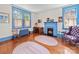 Bright living room with a blue fireplace, hardwood floors, and a classic vintage-style design at 208 Park Ave, Wadesboro, NC 28170