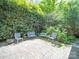 Cozy outdoor patio with brick flooring and comfortable seating, surrounded by lush greenery at 208 Park Ave, Wadesboro, NC 28170