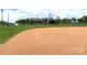 Well-maintained baseball field featuring green grass and vibrant red dirt infield for sports at 211 Worthington St, Shelby, NC 28150