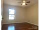 Bedroom featuring hardwood floors, a ceiling fan, a window, and neutral paint at 211 Worthington St, Shelby, NC 28150