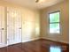 Bedroom featuring hardwood floors, a window, a ceiling fan, and neutral paint at 211 Worthington St, Shelby, NC 28150