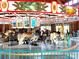 Beautiful carousel with intricately designed horses and ornate paintings above, perfect for Gathering fun at 211 Worthington St, Shelby, NC 28150