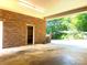 Garage featuring a brick exterior, lighting, and a concrete floor at 211 Worthington St, Shelby, NC 28150
