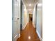 Hallway leading to a brick fireplace and rooms with hardwood flooring at 211 Worthington St, Shelby, NC 28150