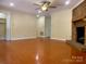 Cozy living room featuring a brick fireplace, hardwood floors, and a ceiling fan at 211 Worthington St, Shelby, NC 28150