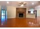 Spacious living room with hardwood floors and a brick fireplace at 211 Worthington St, Shelby, NC 28150