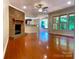 Bright living room with hardwood floors, a fireplace, and a view of the backyard at 211 Worthington St, Shelby, NC 28150