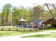 Colorful playground surrounded by lush greenery, offering a safe and fun environment for children at 211 Worthington St, Shelby, NC 28150