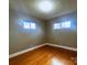 Sunlit bedroom featuring hardwood floors and large windows, creating a warm and inviting space at 215 E K St, Newton, NC 28658