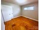 Comfortable bedroom with hardwood floors, a window, and closet, offering a peaceful retreat at 215 E K St, Newton, NC 28658