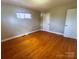 Bright bedroom with hardwood floors, a window, and ample space, perfect for relaxation and rest at 215 E K St, Newton, NC 28658