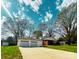 Exterior view of the home and detached garage with a long driveway at 215 E K St, Newton, NC 28658