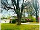 View of the home and detached garage with large trees around the property at 215 E K St, Newton, NC 28658