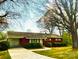 Charming brick home with well-maintained lawn, and lush landscaping at 215 E K St, Newton, NC 28658