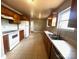 The kitchen features wood cabinets, tile floors, and modern appliances at 215 E K St, Newton, NC 28658