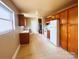 A well-lit kitchen offers ample space, featuring wood cabinets, white appliances, and updated countertops at 215 E K St, Newton, NC 28658