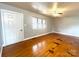 Spacious living room featuring hardwood floors, a ceiling fan, and bright window at 215 E K St, Newton, NC 28658