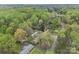 Aerial view showcases the property's landscaping, long driveway, and surrounding mature trees at 2600 Gemway Dr, Charlotte, NC 28216