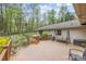 Spacious back deck with swing, overlooking the beautiful backyard with mature trees and landscaped garden at 2600 Gemway Dr, Charlotte, NC 28216