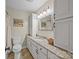 Traditional bathroom with granite countertops, custom cabinets, and decorative mirror at 2600 Gemway Dr, Charlotte, NC 28216