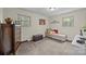 Bedroom with carpet, daybed, dresser, and two large windows offering bright natural light at 2600 Gemway Dr, Charlotte, NC 28216