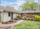 Charming exterior features a wooden deck, brick accents, and professional landscaping at 2600 Gemway Dr, Charlotte, NC 28216